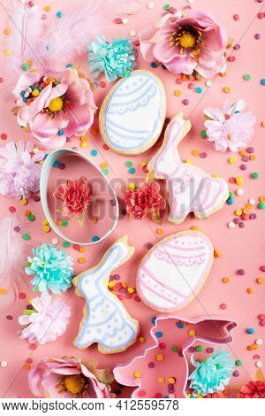 Sugar Sprinkles, Cookie Cutters, Easter Frosted Cookies In Shape Of Egg And Rabbit On Pink Backgroun
