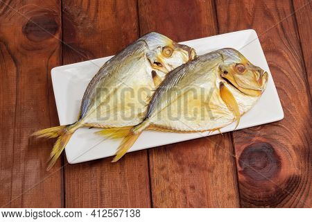 Two Smoked Selene Setapinnis, Also Known As Atlantic Moonfish Or Vomer, On A White Rectangular Dish 