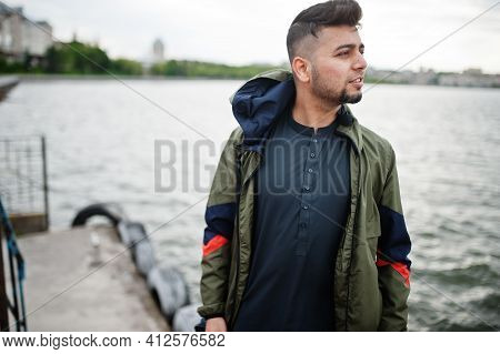 Сonfident Pakistani Indian Muslim Arabic Boy In Grey Kameez Shalwar Suit.