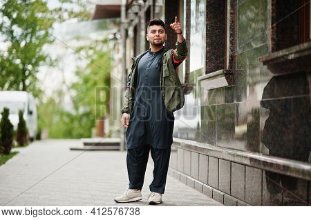 Сonfident Pakistani Indian Muslim Arabic Boy In Grey Kameez Shalwar Suit Show Finger Up.