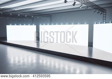 Black Glosy Stage In The Center Of Empty Spacious Hall With White Screens With Copyspace And Dark Co