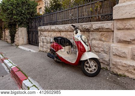 Jerusalem, Israel, February 27, 2021 : Evening View Of An Old Small Scooter Standing On David Marcus