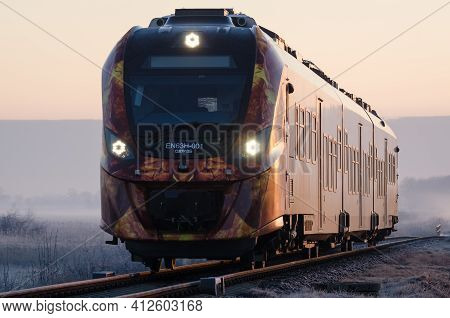 KOLOBRZEG, WEST POMERANIAN - POLAND - 2021: Modern Hybrid Multiple Unit on a trail on a foggy morning