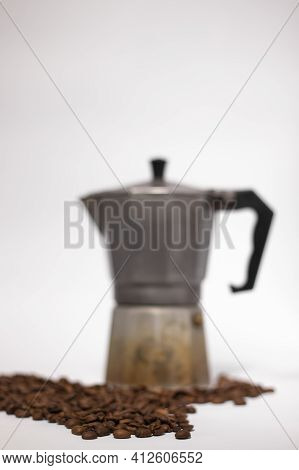 Geyser Coffee Maker Or Moka Pot Isolated On White Background With Coffee Beans Nearby.