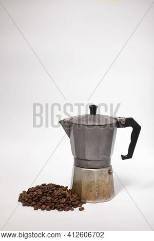 Geyser Coffee Maker Or Moka Pot Isolated On White Background With Coffee Beans Nearby.