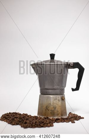 Geyser Coffee Maker Or Moka Pot Isolated On White Background With Coffee Beans Nearby.