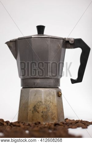Geyser Coffee Maker Or Moka Pot Isolated On White Background With Coffee Beans Nearby.