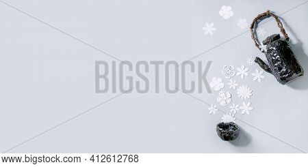 Creative Layout With White Paper Flowers Over Gray