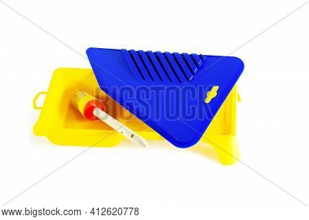 Blue Plastic Spatula For Wallpaper.yellow Paint Cuvette. Close-up. Isolated On White Background.