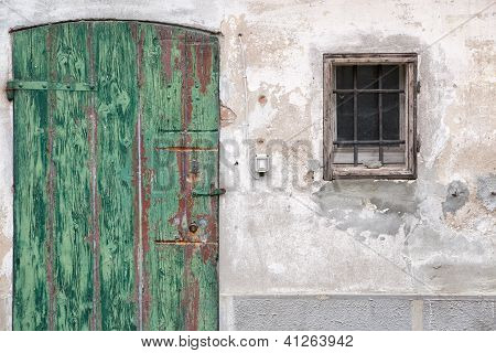 Old wooden door with green paint peeling - Emilia Romagna, Italy