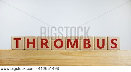 Medical And And Thrombus Symbol. Wooden Cubes With The Word 'thrombus'. Beautiful White Background.