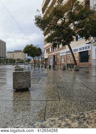 Málaga, Spain - February 22, 2021: Iew Of Famous Málaga Square During The Rain.