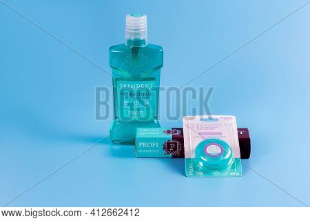 Moscow, Russia - 9 Matra 2021: Mouthwash, Toothpaste And Dental Floss On A Blue Background.the Conce