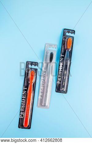 Moscow, Russia - Matra 9 2021: Assortment Of Toothbrushes With Different Bristles On A Blue Backgrou
