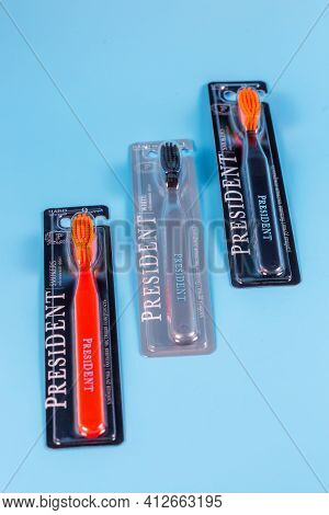 Moscow, Russia - Matra 9 2021: Assortment Of Toothbrushes With Different Bristles On A Blue Backgrou