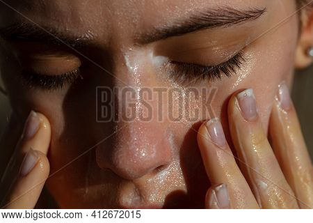 Acne Protection. Girl Washing Face With Cleancing Products. Cosmetics For Skincare