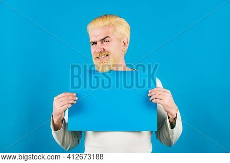 Portrait Of Man Showing Blue Blank Signboard With Copy Space Area For Slogan Or Text. Young Man Show