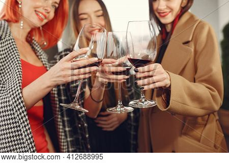 Happy Women Friends Drinking Red Wine Laughing In Teracce