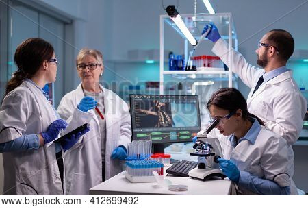 Woman Tehnician Lab Doctor In White Coat Looking Under Microscope Analysing Various Bacteria In Labo