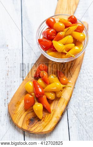 Pickled red and yellow hot chili peppers