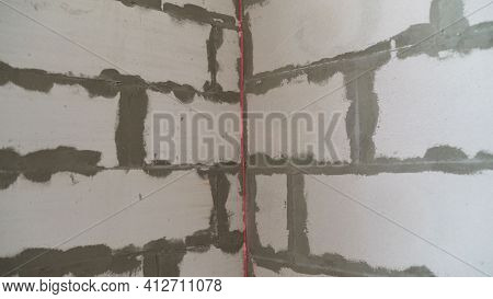 A Builder Makes Arrangements With A Laser Level At A Construction Site. Construction Laser Level And