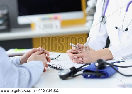 Doctor Communicating With Patient In Clinic Closeup