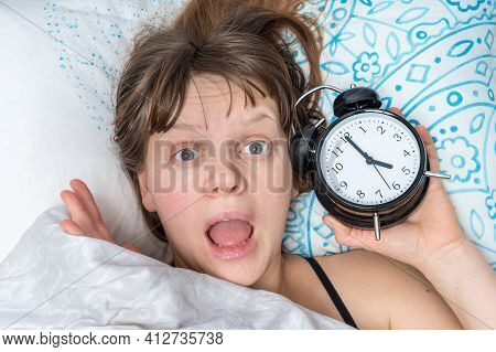 Shocked Woman With Alarm Clock Comes Late To Work Because She Oversleep - Oversleeping Concept