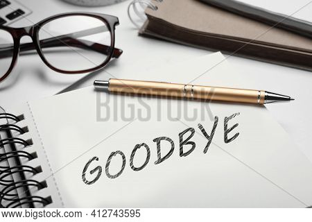 Notebook With Word Goodbye And Pen On Table, Closeup