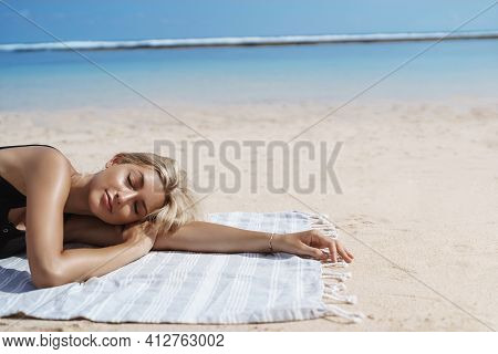 Cropped Shot Of Beautiful Blond Woman Sunbathing On Tropical Beach Near Ocean Shore. Female Tourist 