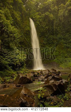 Waterfall Landscape. Beautiful Hidden Waterfall In Tropical Rainforest. Foreground With Big Stones. 