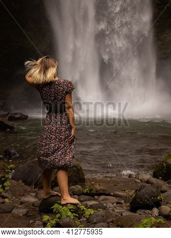 Caucasian Woman Enjoying Waterfall Landscape. Nature And Environment Concept. Travel Lifestyle. Woma