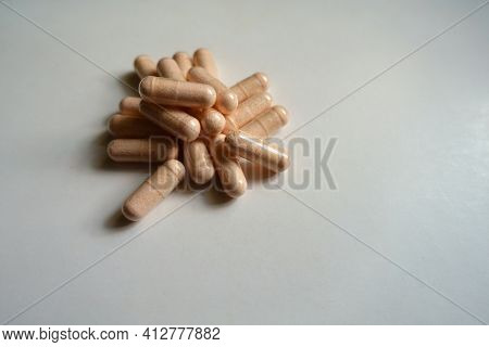 Fistful Of Pink Capsules Of Probiotic Dietary Supplement