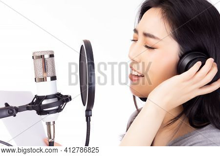 Portrait Young Asian Woman Recording Song In A Recording Studio. Singer Female Performing And Singin