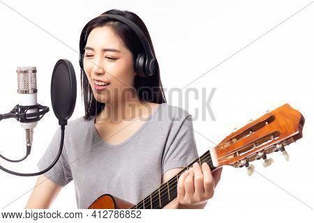 Beautiful Asian Female Singer Playing Guitar And Singing Song By Using Microphone And Pop Filter In 