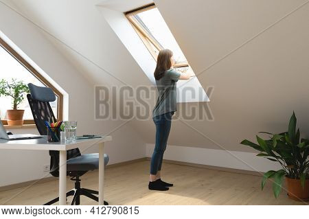 Women Opening A Window At Home Office And Letting Fresh Air In. Healthy Working Environment In New N
