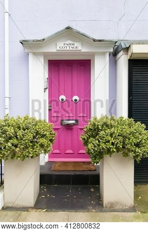 Farm Place, Kensington, London, England, United Kingdom - March 05 2021: Funny Face Pink Door (w8) -