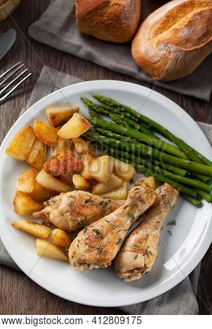 Roast Chicken With Potatoes And Asparagus. High Quality Photo.