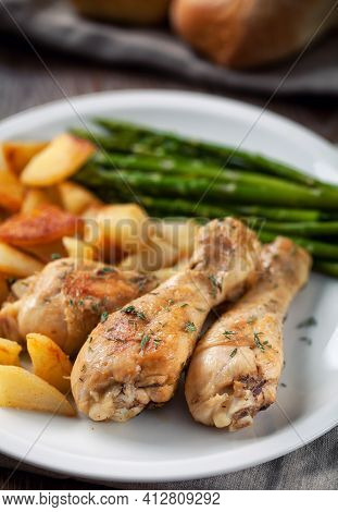 Roast Chicken With Potatoes And Asparagus. High Quality Photo.