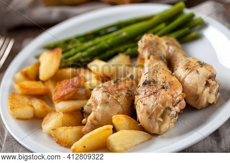 Roast Chicken With Potatoes And Asparagus. High Quality Photo.