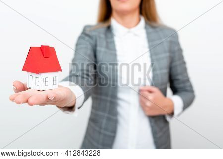 Holding Your New House In Hands Against Spring Green Background. Real Estate And Healthy Lifestyle C
