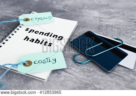 Spending Habits Text On Notepad With Payment Cards And Cheap Vs Costly Prioduct Price Tags Next To I