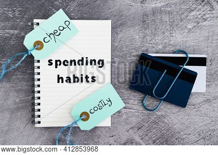 Spending Habits Text On Notepad With Payment Cards And Cheap Vs Costly Prioduct Price Tags Next To I