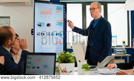 Mature Ceo Cto Executive Director Presenting Statistical Data, Financial Project Briefing Diverse Gr