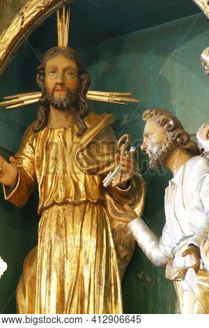 SVETI PETAR MREZNICKI, CROATIA - JULY 14, 2013: Jesus gives the keys to St. Peter, a statue on the high altar in St. Peter's Parish Church in Sveti Petar Mreznicki, Croatia