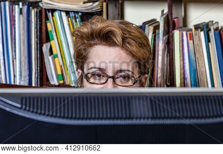 Portrait Of A Busy Woman Telecommuting At Her Desk At The Home. Working At Home Became An Important 