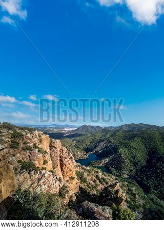 Rocks With Layers, Mountain Range And Dam