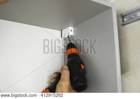 Installing A Hardware Kitchen Cabinet Suspension Brackets On A Custom Kitchen From A Chipboard Mater