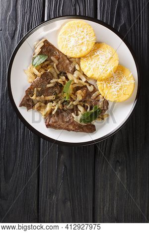 Fried Beef Liver With Onion And Sage, Served With Polenta Close-up In A Plate On The Table. Vertical