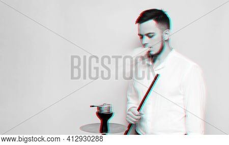Glitch Effect. A Male Model Smokes A Hookah, Sheesha And Enjoys It. Pink Background.