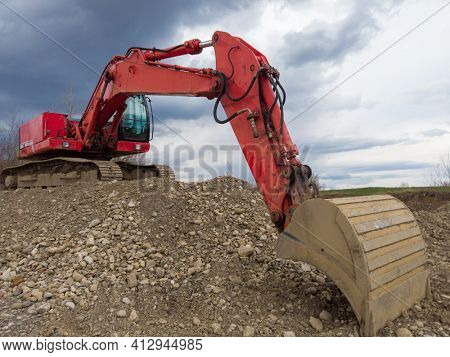 Illegal exploating of grader with excavator on river bank